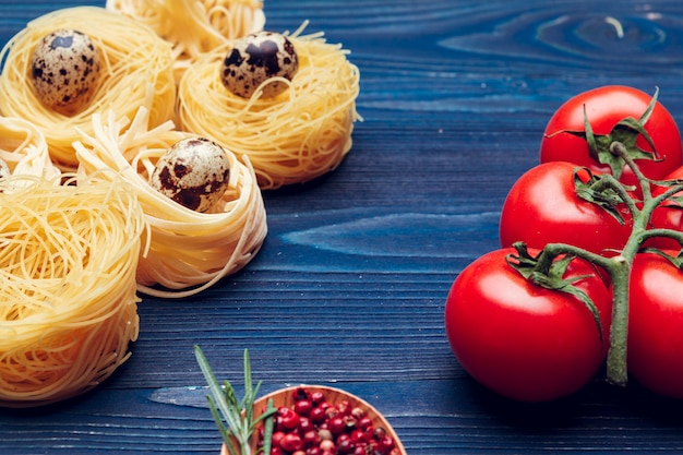 Close up of a raw dry italian pasta fettuccine on blue wooden