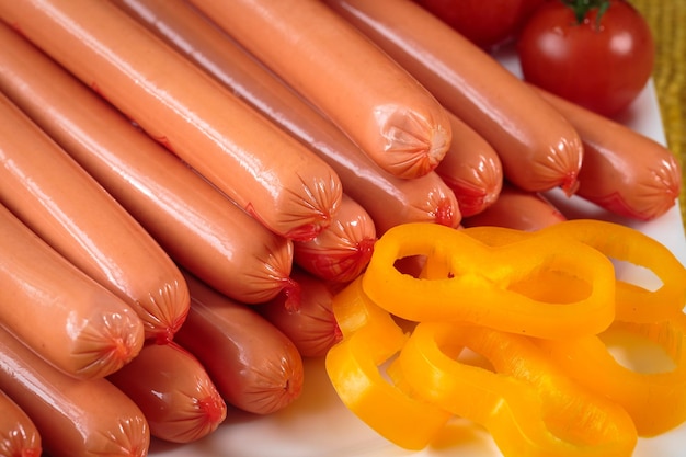 Close up of raw frankfurter sausages on white plate