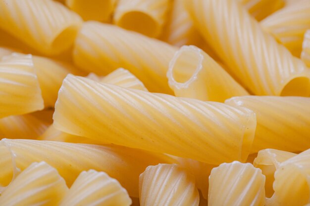 Close up raw italian durum wheat pasta tortiglioni background top view