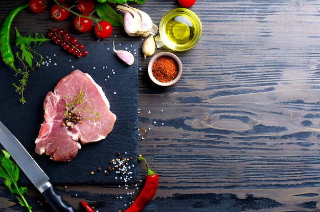 Close up on raw steak of pork meat with various ingredients