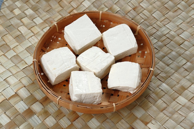 Close up of raw tahu putih or tofu in bamboo basket