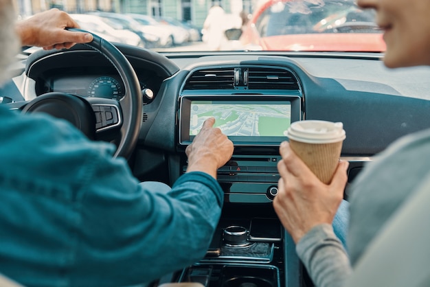 Close up rear view of active senior couple using global positioning system.