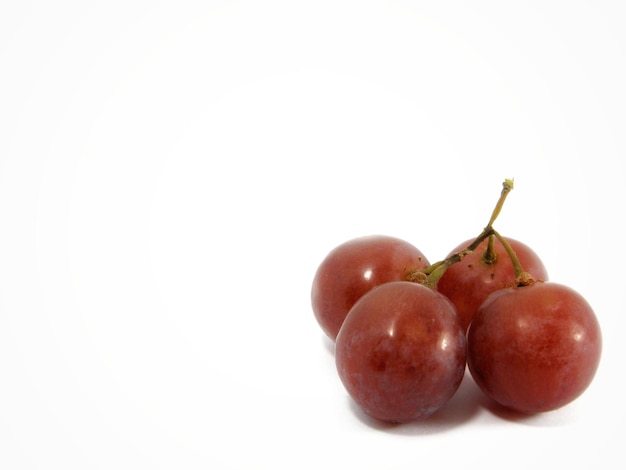 Close-up of red grapes on a white background