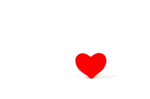 Photo close-up of red heart shape over white background