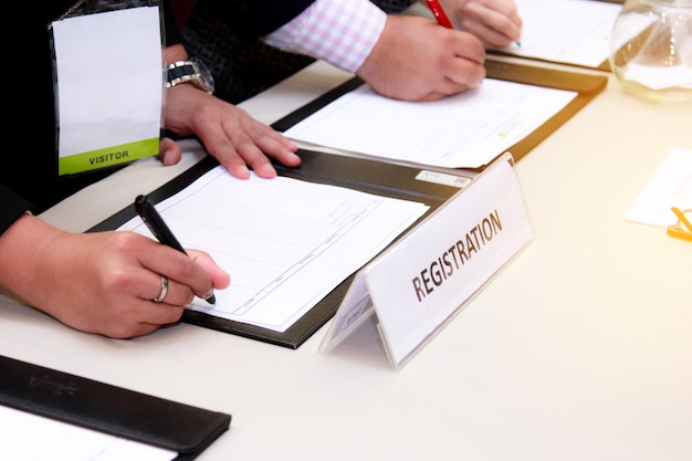 close-up of registration desk in front of conference center with Businessman