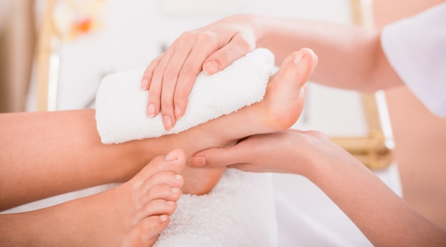 Close-up of relaxation pedicure process in spa salon.