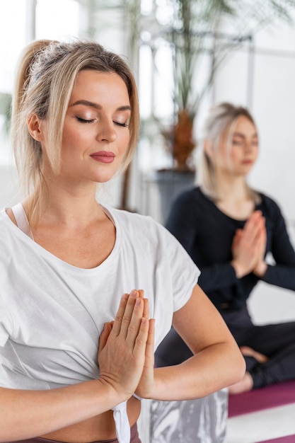 Close up relaxed women meditating