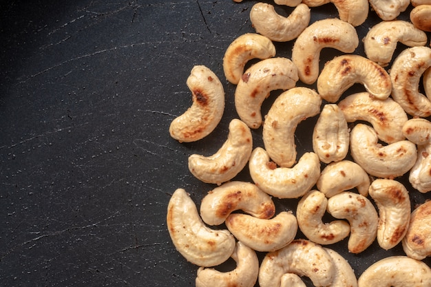 Close-up Roasted cashew nuts and salt in a pan. 