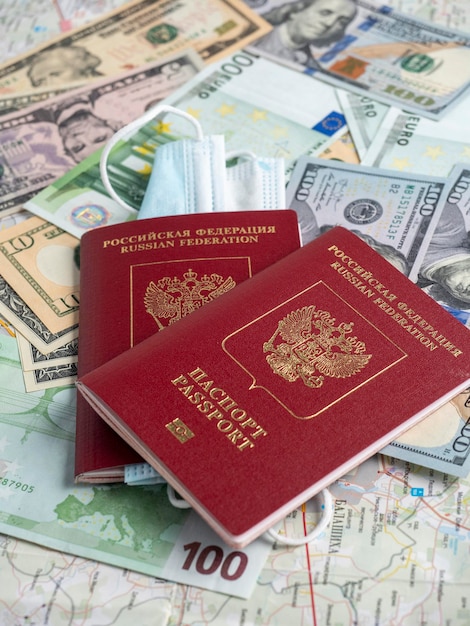 A close-up of a Russian passport with embedded dollar bills is on the map. The concept of travel and recreation.. Side view