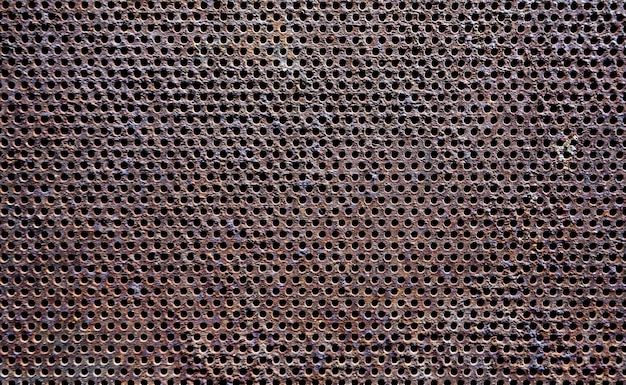 Close-up of rusty metal with holes for background and texture