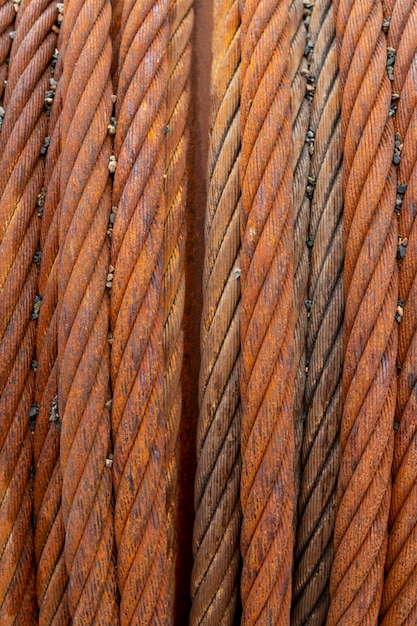 Close up of rusty steel cable coiled on a drum.