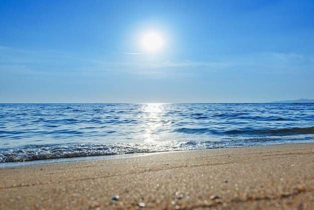 Close up sand beach with clear blue sea and sky