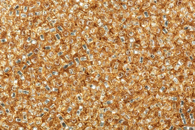 Close-up of sandy brown seed beads. High resolution photo.