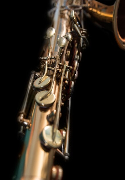 Close-up of saxophone against black background