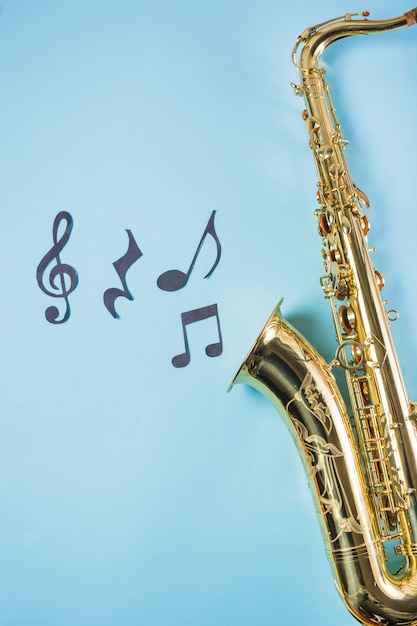 Close-up of saxophones with musical notes on blue background