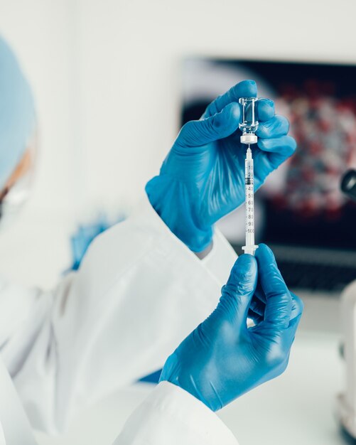 Close up. scientist filling a syringe with a new vaccine. photo with a copy-space.