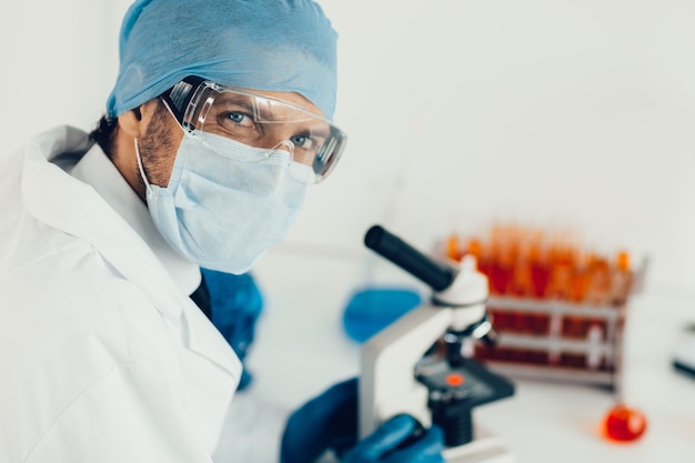 Close up. scientist looking at a control sample through a microscope. photo with a copy-space.