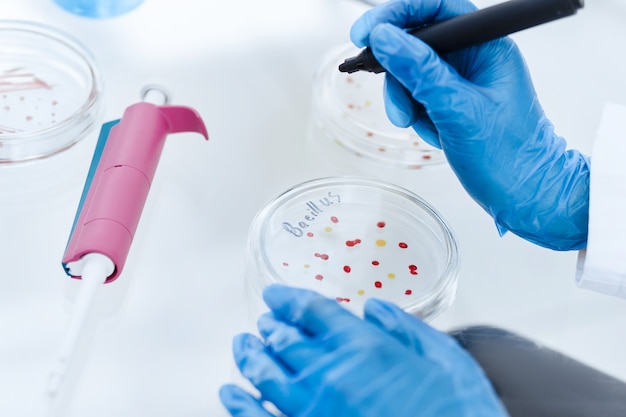 Close up. scientist marking a Petri dish with viral bacteria. science and health.