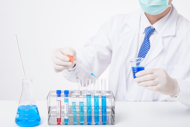 Close up of scientist testing and researching some blue liquid chemical