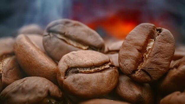 Close up of seeds of coffee. Fragrant coffee beans are roasted smoke comes from coffee beans.