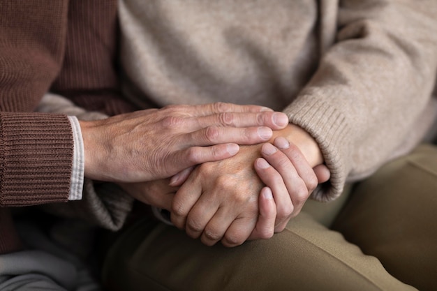 Close-up senior couple holding hands