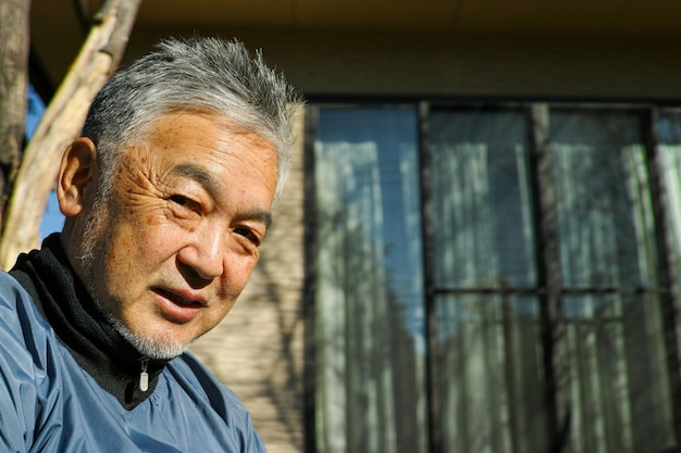 Close-up of senior man looking down outdoors