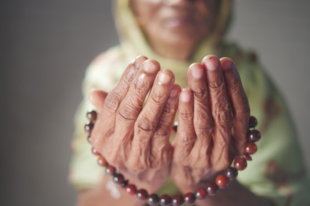 Close up of senior women hand praying at ramadan