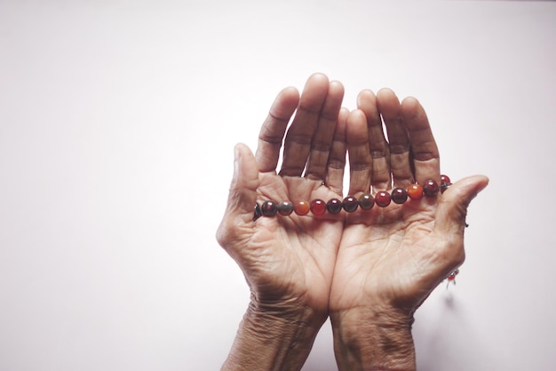 Close up of senior women hand praying at ramadan