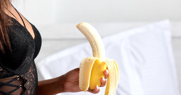 Close-up of sensual woman eating banana. Oral sex concept.