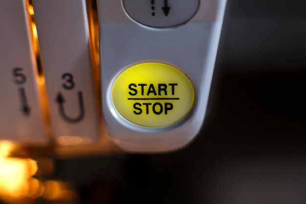 Photo close-up of a sewing machine button