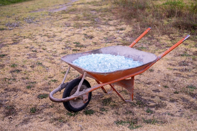 A close up of Shattered glass in a wheelbarrow