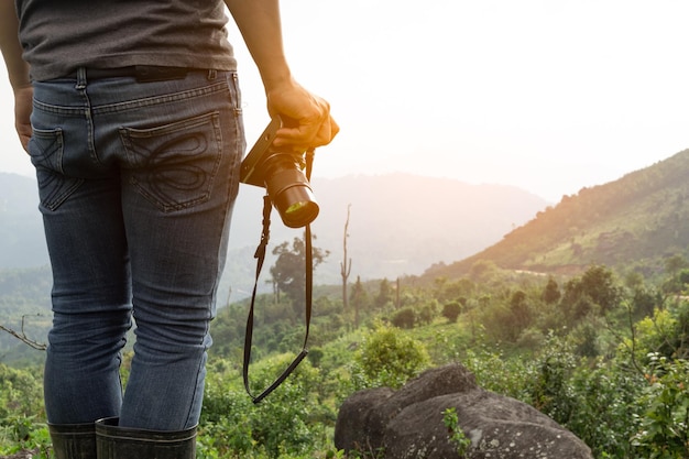 Close up shot of Asian man catching camera travel alone at mountain