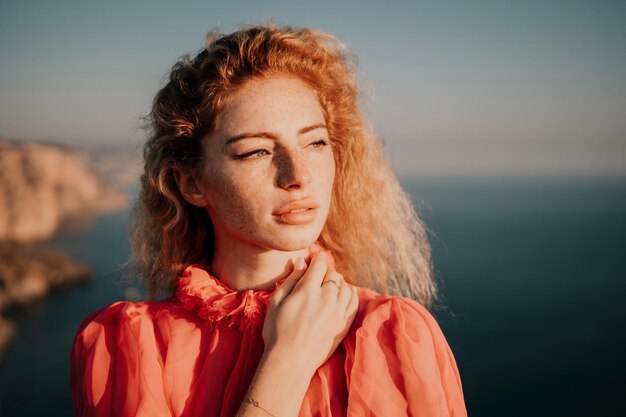 Close up shot of beautiful young caucasian woman with curly blond hair and freckles looking at