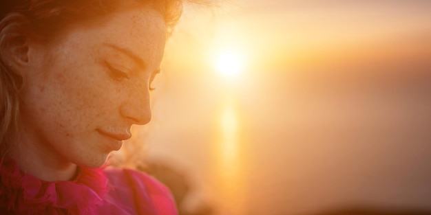 Close up shot of beautiful young caucasian woman with curly blond hair and freckles looking at