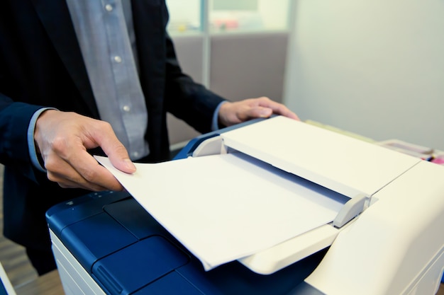 Photo close-up shot businessmen are using photocopiers.