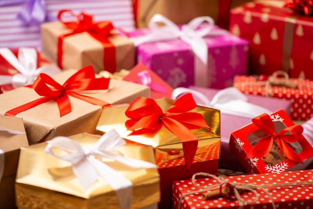 Close up shot of Christmas presents on the floor under Christmas tree Bright gift boxes Christmas eve decoration