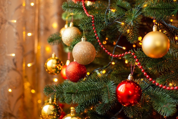 Close up shot of Christmas tree with bright lights on the background