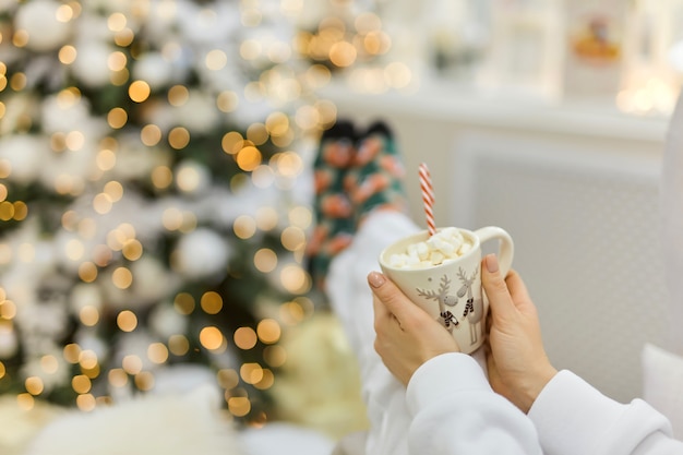 Close-up shot of a cup of warm cocoa in hands