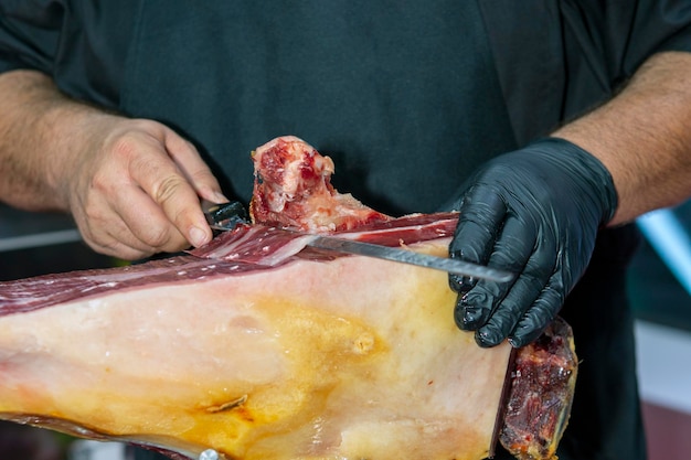 Close up shot cutting iberian ham