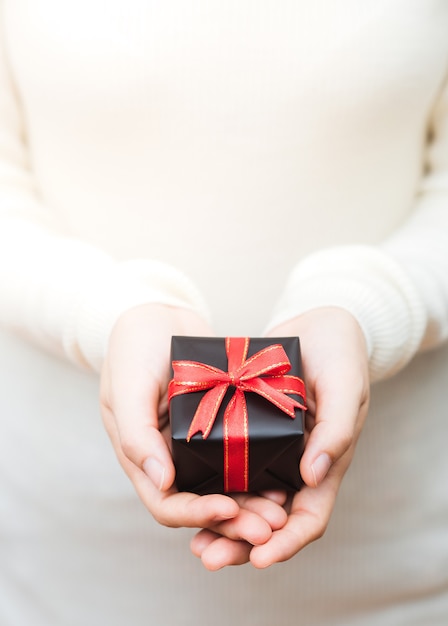 Close up shot of female holding a small gift wrapped