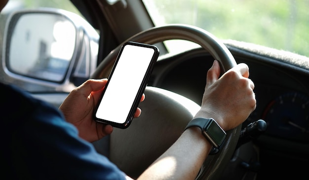 Close up shot of man using smartphone in car