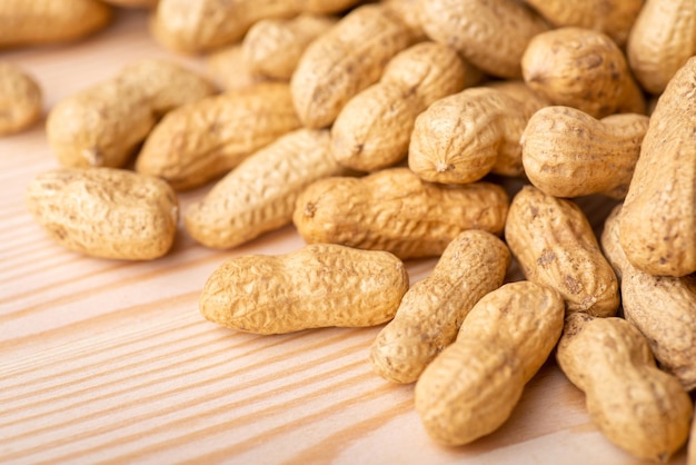 Close up shot of peanuts on wooden table