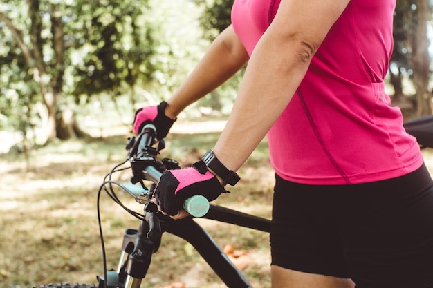 Close up shot of a person's hands holding a bicycle. concept sport and cycling in the air or nature.