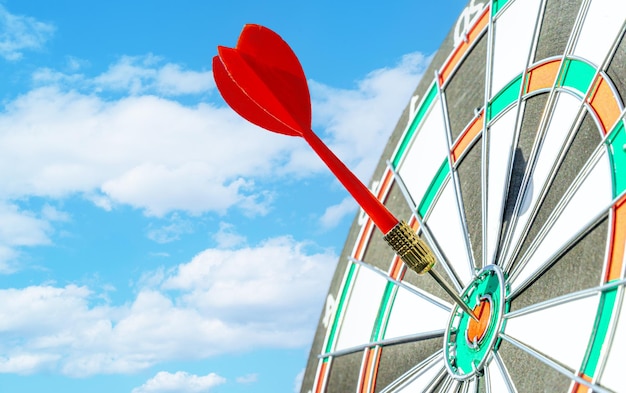 Close up shot red darts arrows in the target arrow hitting the center of a shooting target for business close targeting and good successBusiness target or goal success and winner concept