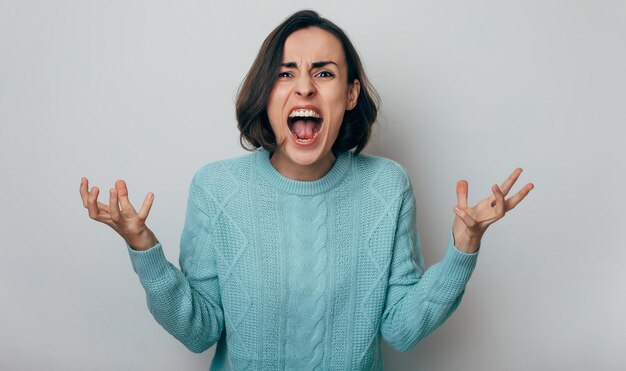 Close up shot of screaming crazy frustrated woman with anxiety anger and depression Very upset and emotional woman crying Young girl with angry and furious face Human expressions and emotions