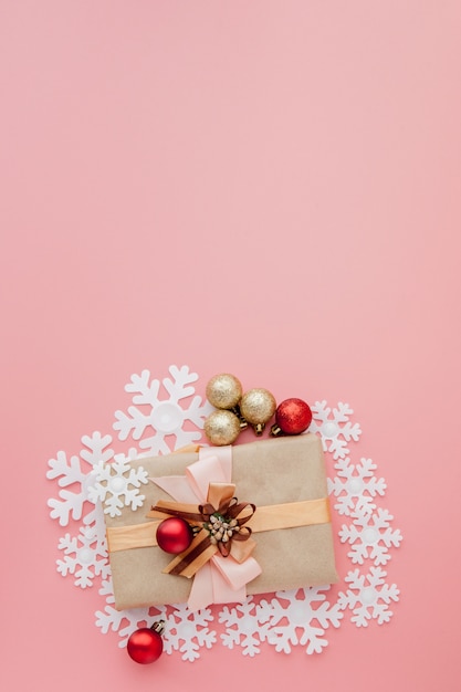 Close up shot of small gift wrapped with ribbon. Christmas background. Minimal concept. Flat lay. Top view