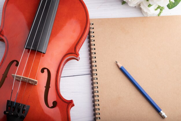 Close-up shot violin orchestra instrumental and notebook