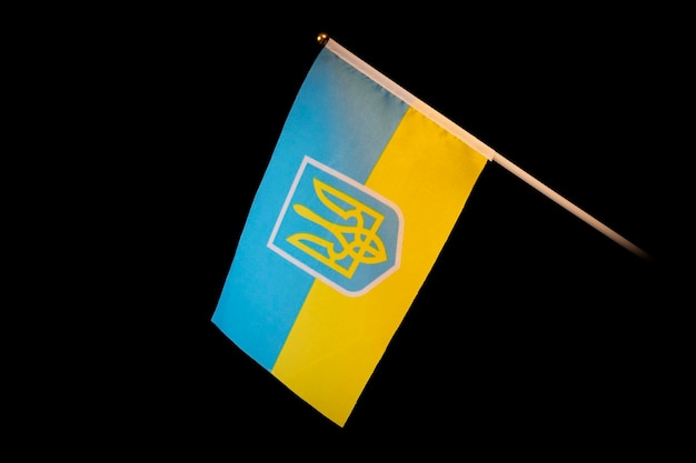 Close up shot of waving ukrainian flag over black background