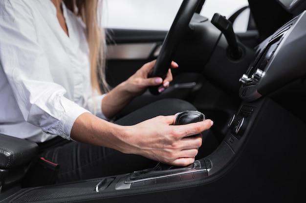 Close-up shot with a woman shifting gears