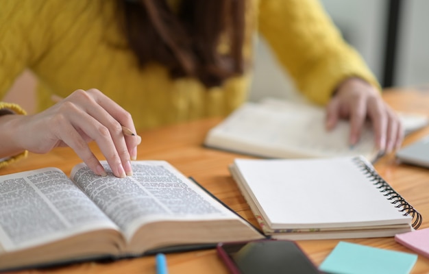 Close up shot of Young women wearing yellow clothes are reading books to prepare for college entrance exams.